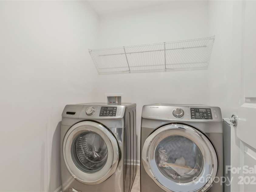 14224 Canemeadow Drive, Charlotte, NC 28278.  MLS# CAR4246314, YatesRealty ID 13517. Laundry room with storage shelf. The washer and dryer comes with the home
