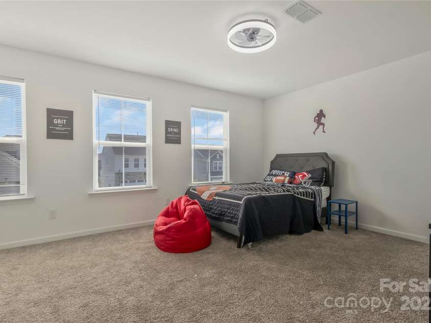 14224 Canemeadow Drive, Charlotte, NC 28278.  MLS# CAR4246314, YatesRealty ID 13517. Secondary bedroom with upgraded lighting with ceiling fan and huge walk-in closet