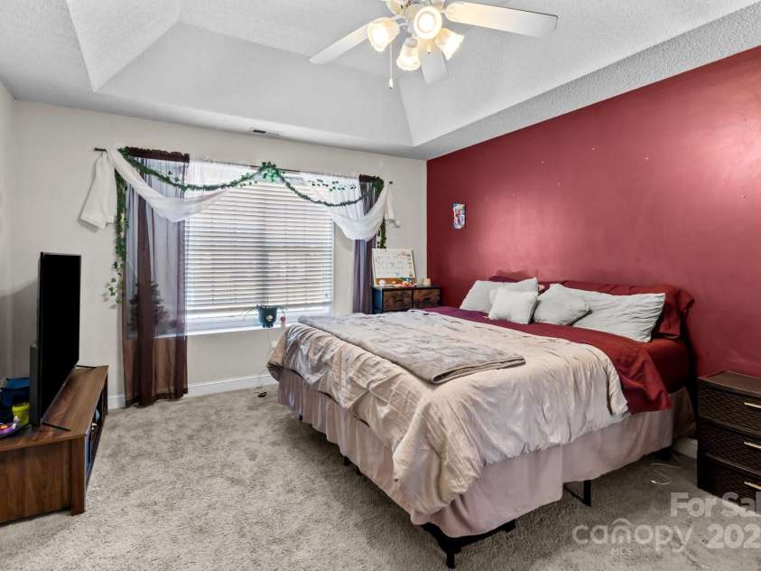 697 Maple Ridge Circle, Salisbury, NC 28147.  MLS# CAR4205711, YatesRealty ID 1353. Primary bedroom with tray ceiling and large window