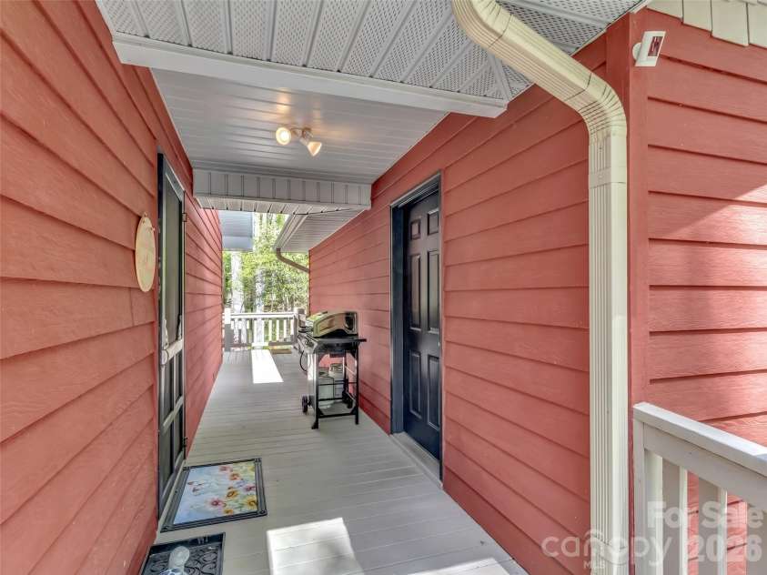 211 Rustic Road, Waynesville, NC 28786.  MLS# CAR4371760, YatesRealty ID 13537. Breezeway Between House & Garage