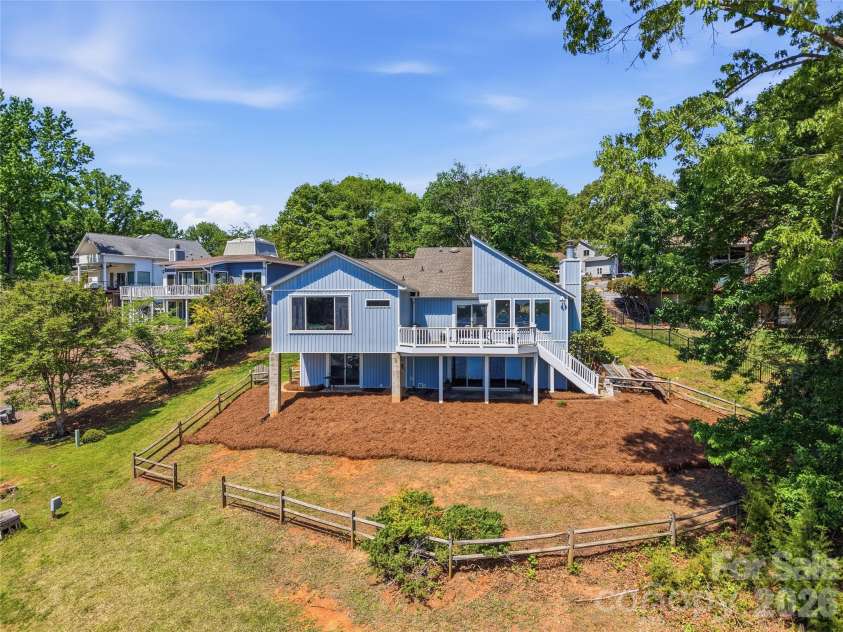 19011 Kailua Circle, Tega Cay, SC 29708.  MLS# CAR4367824, YatesRealty ID 13553. LIVE THE DREAM on Lake Wylie in this beautiful waterfront home w/ covered patio, composite deck, gently sloping yard for easy access to the lake, &  covered dock w/ lift and the main channel of Lake Wylie
