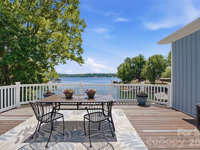 19011 Kailua Circle, Tega Cay, SC 29708.  MLS# CAR4367824, YatesRealty ID 13553. You’ll spend hours lingering over morning coffee, reading a book, or relaxing & enjoying the impressive lake views from the fabulous composite deck 