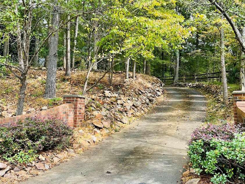 701 Whippoorwill Lane, Concord, NC 28025.  MLS# CAR4188719, YatesRealty ID 1358. Driveway with stonewalls