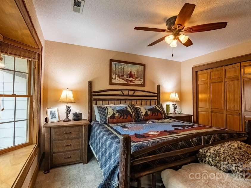 620 Sapphire Valley Road, Cashiers, NC 28717.  MLS# CAR4329121, YatesRealty ID 1359. En-Suite Bed/Bath #1 looking over the Horsepasture River out back. All of this suite's furniture does not convey.
