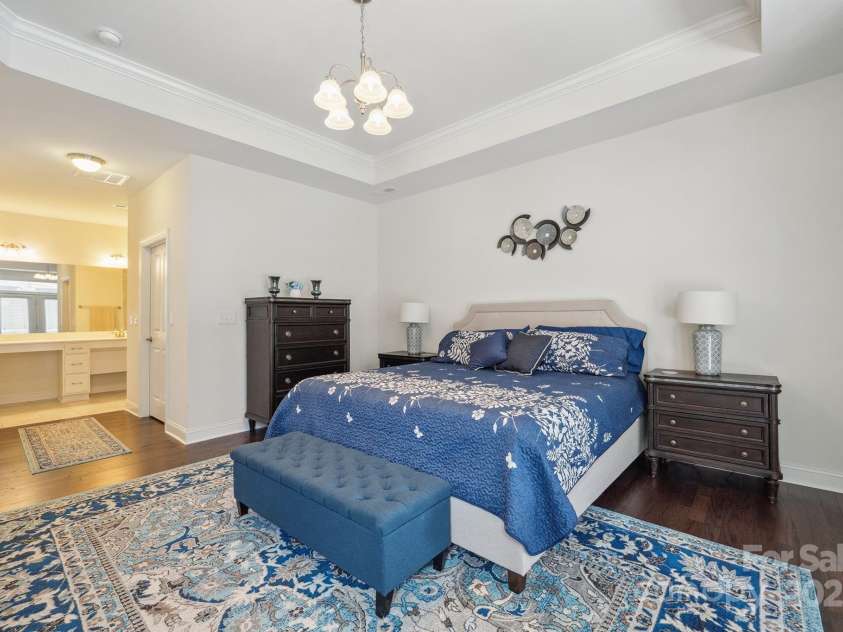 16112 Lakeside Loop Lane, Cornelius, NC 28031.  MLS# CAR4253709, YatesRealty ID 13594. Spacious Primary Suite with tray ceiling/crown molding, patio access, private bath & walk in closet!
