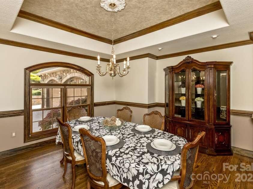 22 Valley Drive, Weaverville, NC 28787.  MLS# CAR4244497, YatesRealty ID 13599. Formal gatherings in the open concept tray-ceiling Dining Room features a view of the front waterfall.