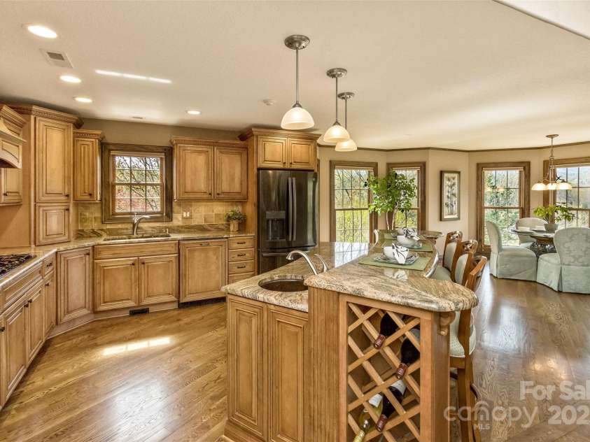 22 Valley Drive, Weaverville, NC 28787.  MLS# CAR4244497, YatesRealty ID 13599. The smart-design kitchen will ignite your creativity with its 5-burner gas cooktop w/pot filler and professional vent hood, double convection wall oven w/microwave, prep sink with 2nd garbage disposal, plentiful well-app