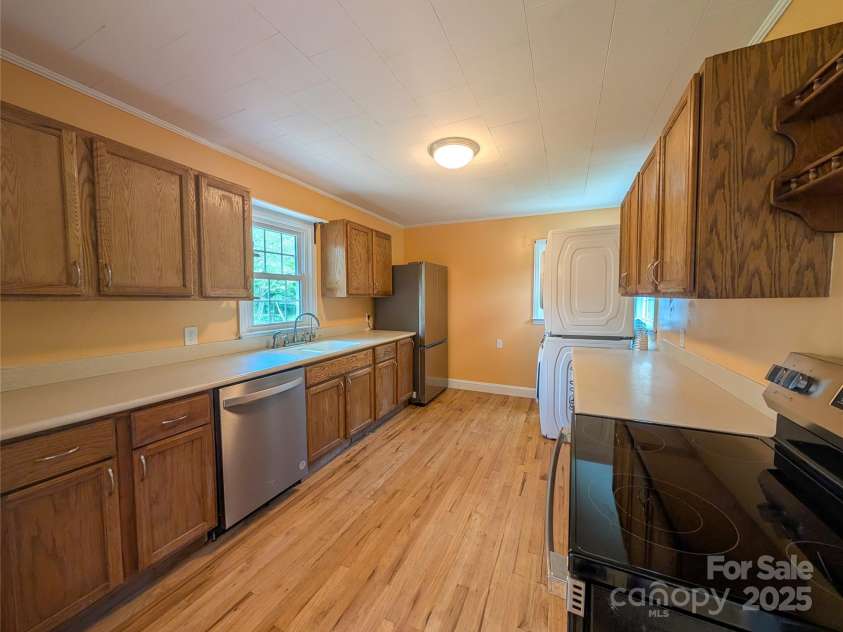 95 Lady Bug Lane, Burnsville, NC 28714.  MLS# CAR4206406, YatesRealty ID 13600. Kitchen with brand new dishwasher, electric range and refrigerator. Stack washer & dryer is not new but does convey.