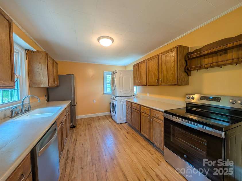 95 Lady Bug Lane, Burnsville, NC 28714.  MLS# CAR4206406, YatesRealty ID 13600. Kitchen with brand new dishwasher, electric range and refrigerator. Stack washer & dryer is not new but does convey.