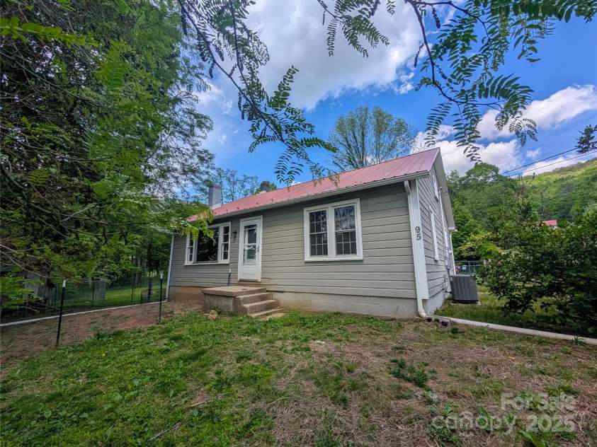 95 Lady Bug Lane, Burnsville, NC 28714.  MLS# CAR4206406, YatesRealty ID 13600. View from back of property. Door leading to living area. Chicken coop to the left is already set up