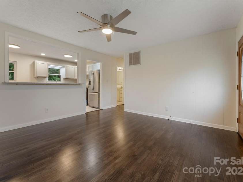 41 Aiken Street, Brevard, NC 28712.  MLS# CAR4259232, YatesRealty ID 13609. Spacious living room opens to kitchen.