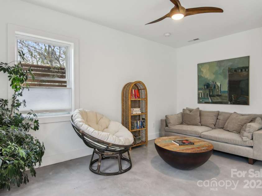 65 Wellington Street, Asheville, NC 28806.  MLS# CAR4234732, YatesRealty ID 13612. Basement level living room