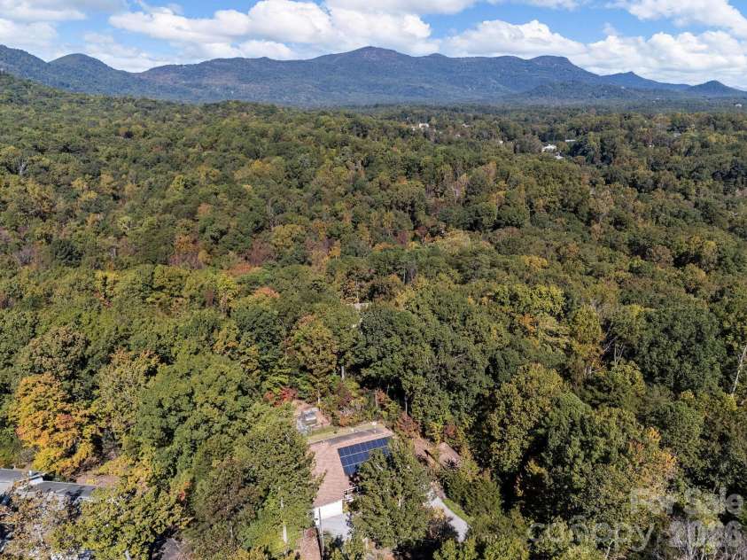 160 Caledonia Road, Landrum, SC 29356.  MLS# CAR4314636, YatesRealty ID 13619. Drone view of mountains