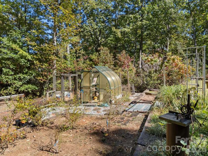 160 Caledonia Road, Landrum, SC 29356.  MLS# CAR4314636, YatesRealty ID 13619. Greenhouse and garden area