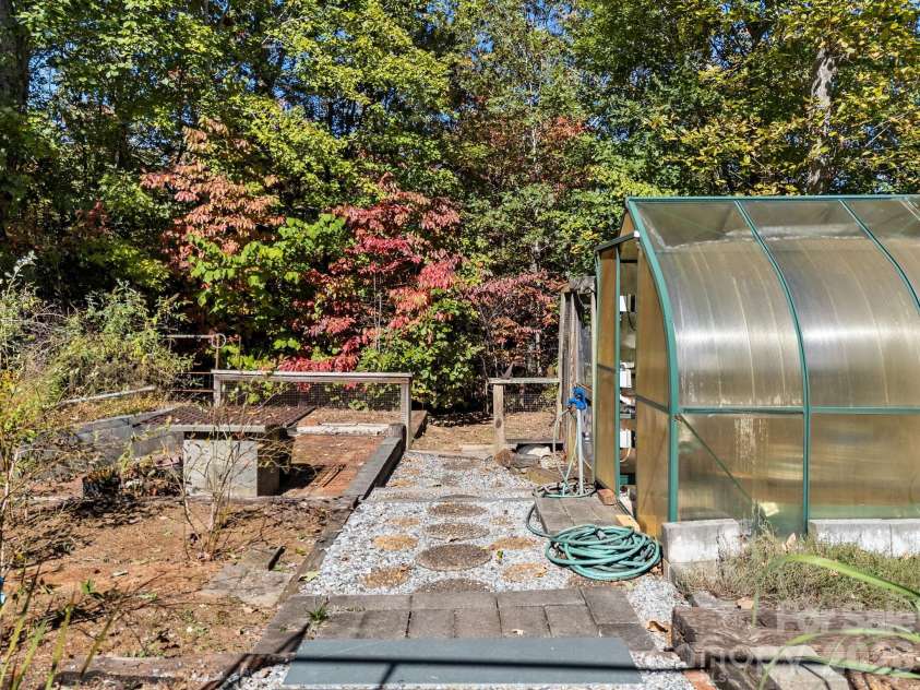 160 Caledonia Road, Landrum, SC 29356.  MLS# CAR4314636, YatesRealty ID 13619. Greenhouse and garden area
