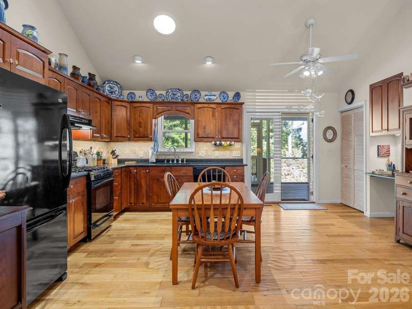 160 Caledonia Road, Landrum, SC 29356.  MLS# CAR4314636, YatesRealty ID 13619. Kitchen with access to screened porch