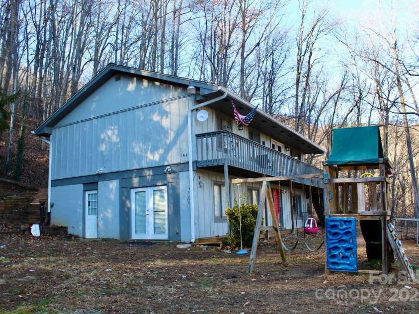 141 Charity Lane, Candler, NC 28715.  MLS# CAR4204175, YatesRealty ID 1364. Side of home