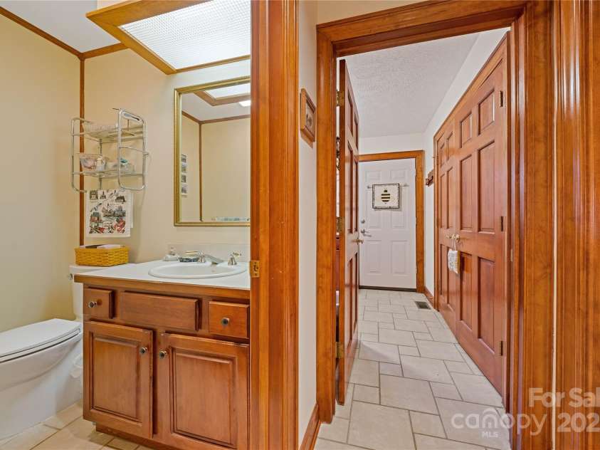 3001 Hickory Nut Trail, Hendersonville, NC 28739.  MLS# CAR4234402, YatesRealty ID 13641. Half bath by garage entry on the way to the laundry room