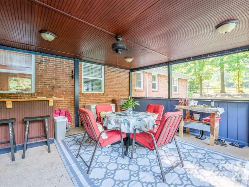 4805 Nesbit Road, Monroe, NC 28112.  MLS# CAR4254388, YatesRealty ID 13650. Screened in porch with high bar, room for outdoor dining. Beautiful ceiling