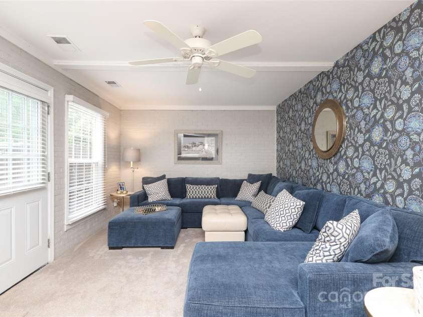 8306 Knights Bridge Road, Charlotte, NC 28210.  MLS# CAR4257820, YatesRealty ID 13656. Massive lower level Den/Family Room!  Door to patio on the left.