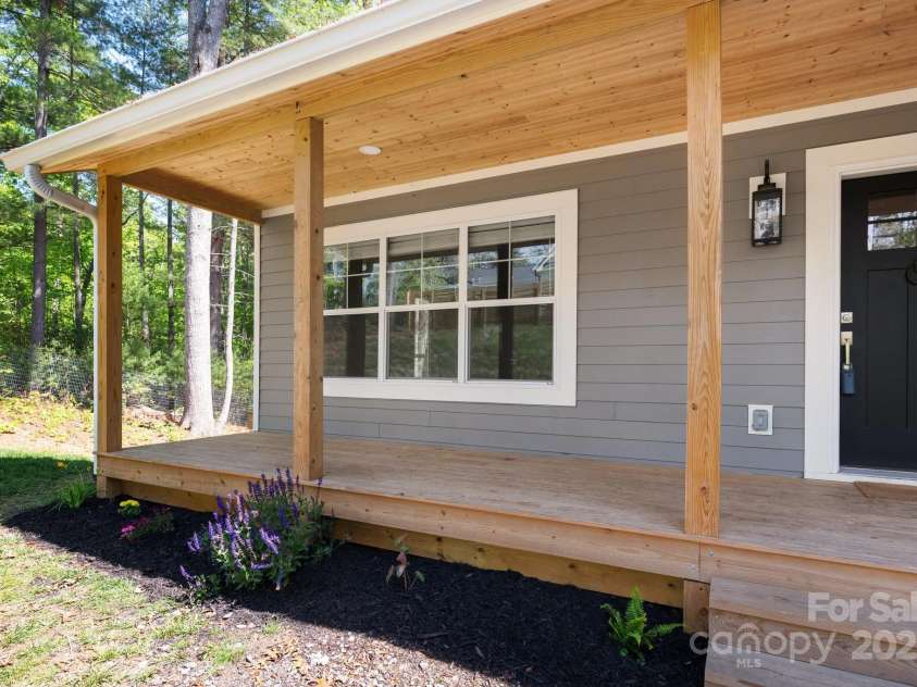 115 Summer Pine Lane, Fairview, NC 28730.  MLS# CAR4252070, YatesRealty ID 13675. Welcoming rocking chair front porch with wood ceiling