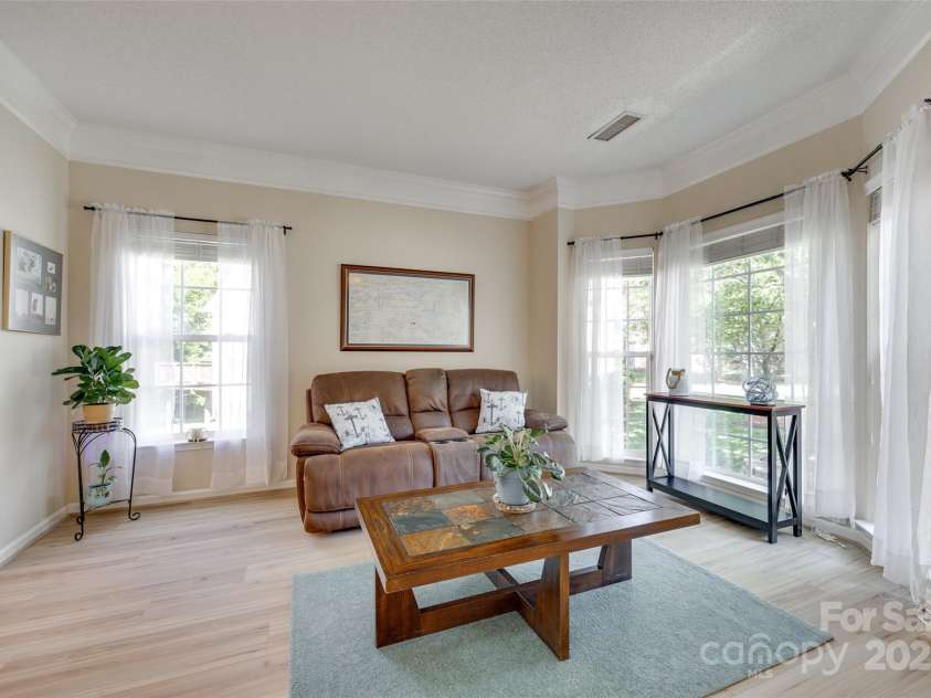 9700 Stewart Spring Lane, Charlotte, NC 28216.  MLS# CAR4252858, YatesRealty ID 13687. Formal living room/flex room with bay windows and new flooring