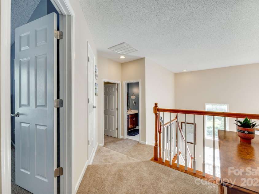 9700 Stewart Spring Lane, Charlotte, NC 28216.  MLS# CAR4252858, YatesRealty ID 13687. Hallway/upstairs landing overlooking two story great room