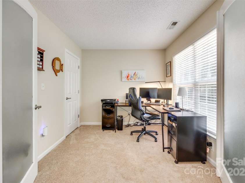 9700 Stewart Spring Lane, Charlotte, NC 28216.  MLS# CAR4252858, YatesRealty ID 13687. Office with French doors off primary bedroom