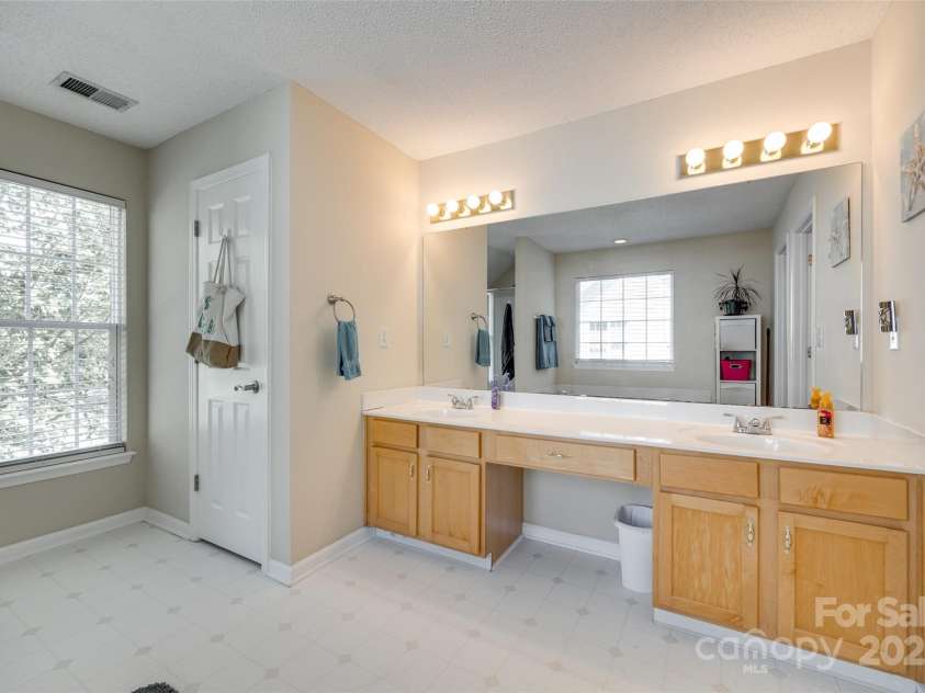 9700 Stewart Spring Lane, Charlotte, NC 28216.  MLS# CAR4252858, YatesRealty ID 13687. Primary bathroom with double sinks