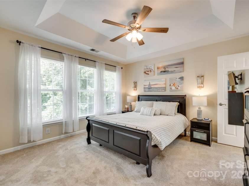 9700 Stewart Spring Lane, Charlotte, NC 28216.  MLS# CAR4252858, YatesRealty ID 13687. Primary bedroom with tray ceiling, new carpet and large windows