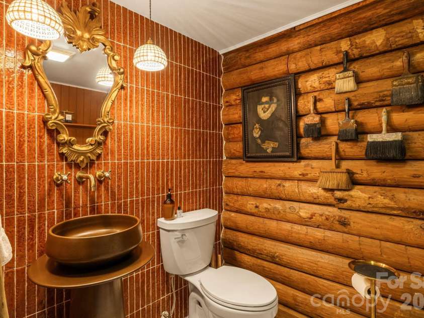 16 Decker Drive, Asheville, NC 28803.  MLS# CAR4355607, YatesRealty ID 13690. Even the first floor powder room is elevated and features premium designer ceramic tile on floor and walls.