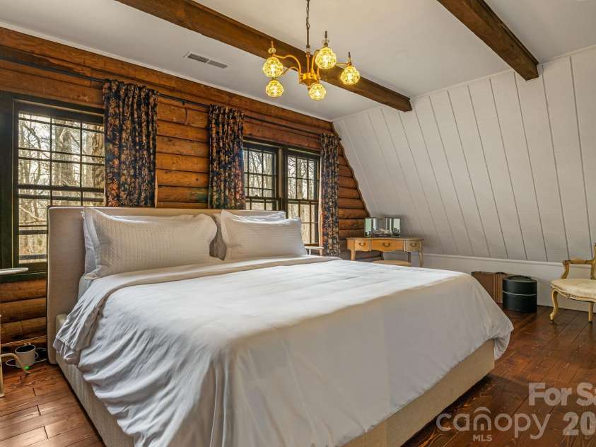 16 Decker Drive, Asheville, NC 28803.  MLS# CAR4355607, YatesRealty ID 13690. The rustic charm and natural elements continue in the spacious primary bedroom.