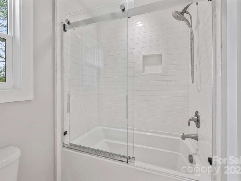 95 Beaver Drive, Asheville, NC 28804.  MLS# CAR4258303, YatesRealty ID 13700. Bathroom with Glass Door and Subway Tile