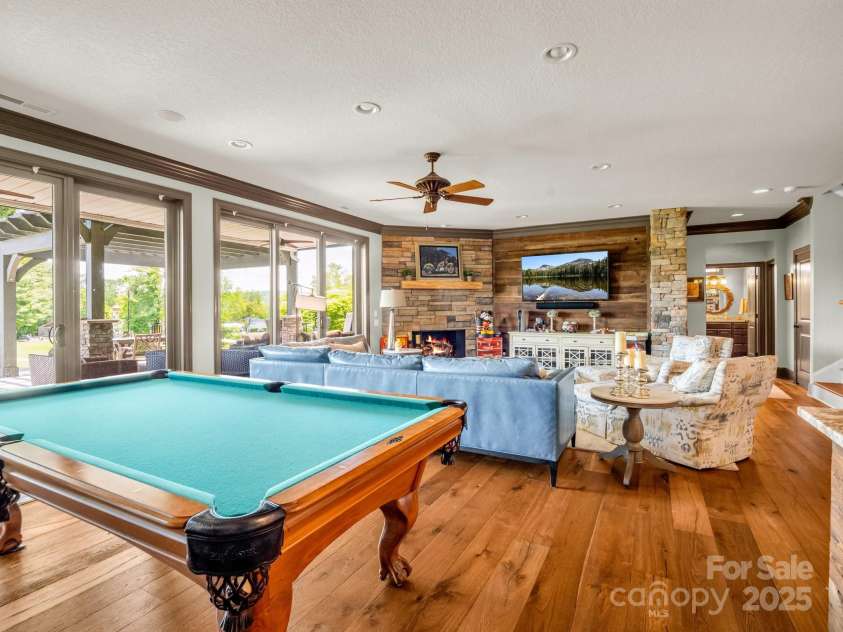 1903 Country Club Road, Hendersonville, NC 28739.  MLS# CAR4258556, YatesRealty ID 13720. Fireplace and natural light, opening to lower porch area