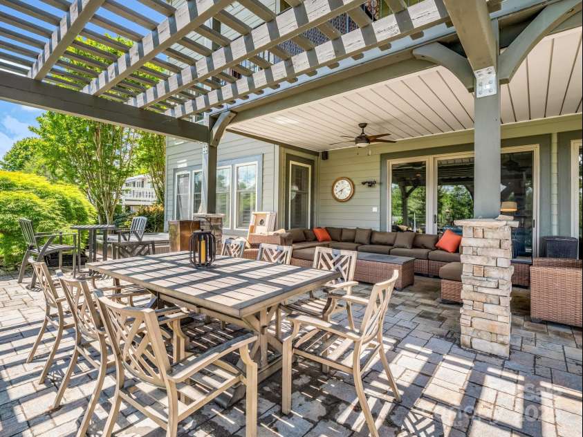 1903 Country Club Road, Hendersonville, NC 28739.  MLS# CAR4258556, YatesRealty ID 13720. Outdoor eating area with arbor, hot tub in background