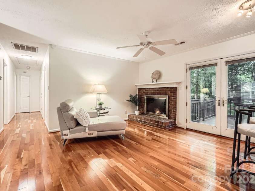 4145 Wall Street, Charlotte, NC 28209.  MLS# CAR4215362, YatesRealty ID 13725. Family room is open and adorned with a brick fireplace and opens to the large back decks.