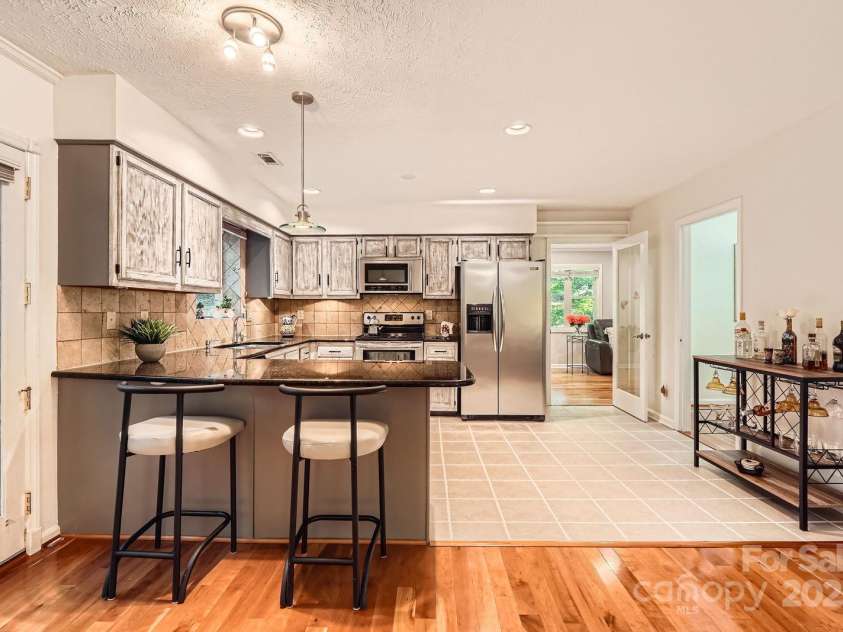 4145 Wall Street, Charlotte, NC 28209.  MLS# CAR4215362, YatesRealty ID 13725. Kitchen offers bar seating for quick meals.