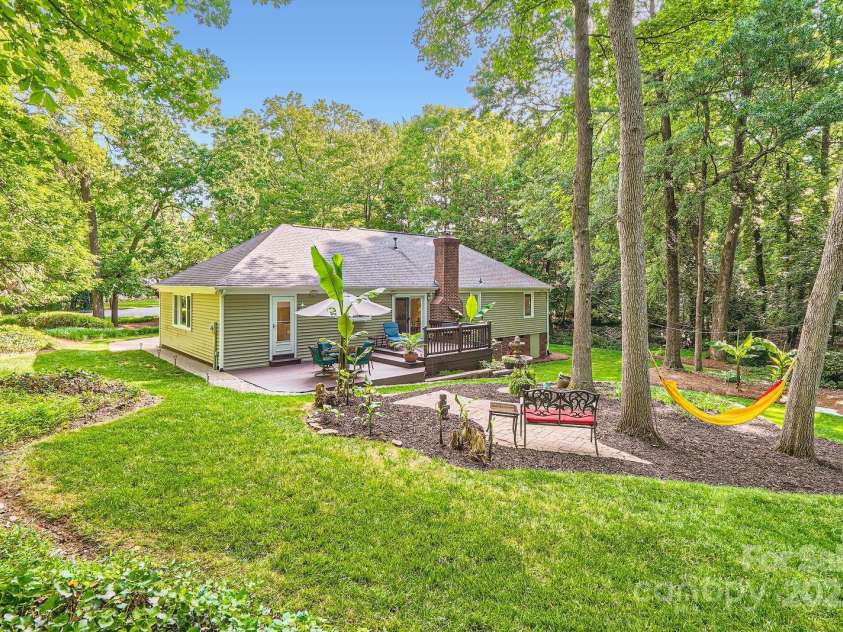 4145 Wall Street, Charlotte, NC 28209.  MLS# CAR4215362, YatesRealty ID 13725. This private back yard offers mature landscaping, tropical banana trees, a hammock, deck and fire pit.