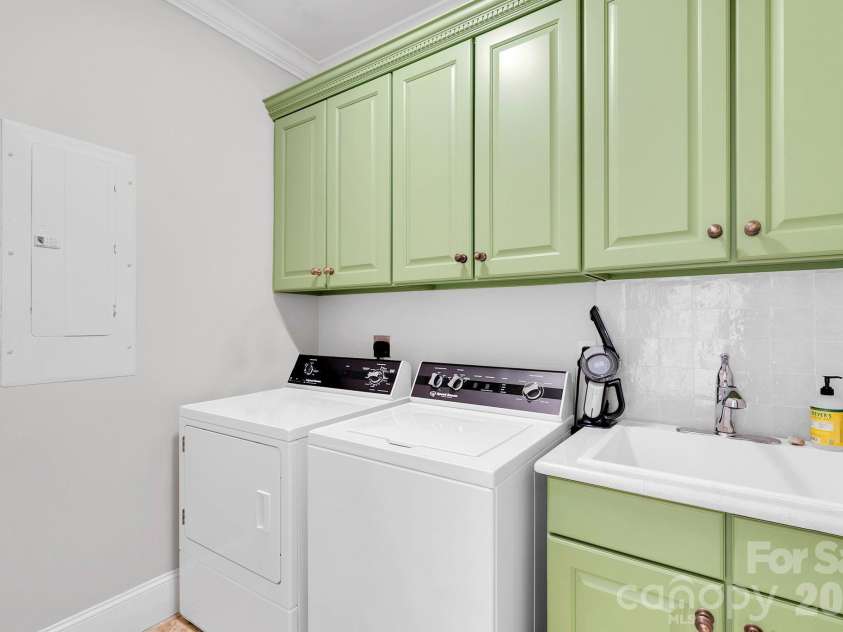 7778 Burning Ridge Drive, Stanley, NC 28164.  MLS# CAR4336313, YatesRealty ID 13726. Functional laundry room equipped with washer and dryer connections, utility sink, and built-in cabinetry for storage (washer & dryer do not convey)