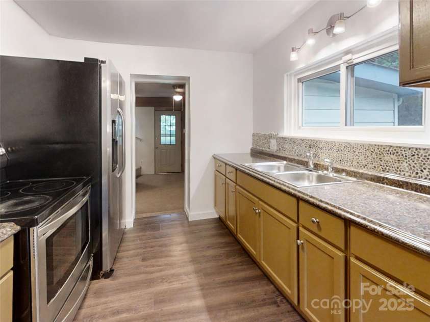120 Harrison Street, Swannanoa, NC 28778.  MLS# CAR4292286, YatesRealty ID 13741. Kitchen facing den