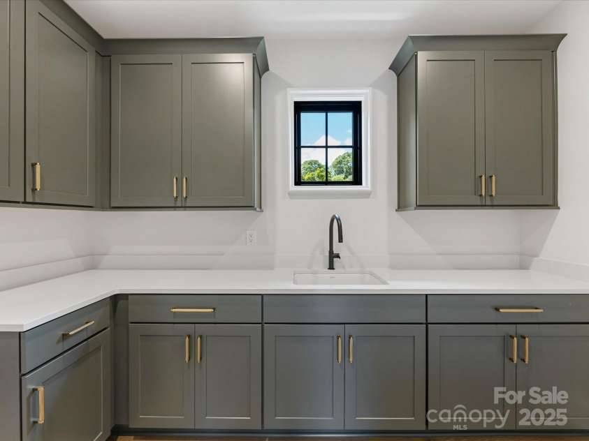 2608 Croydon Road, Charlotte, NC 28209.  MLS# CAR4255600, YatesRealty ID 13742. Storage-filled Laundry Room