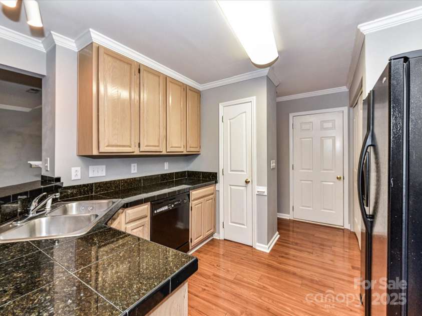 4743 Morning Dew Court, Charlotte, NC 28269.  MLS# CAR4244275, YatesRealty ID 13756. Kitchen featuring a double sink and ample cabinetry for storage!