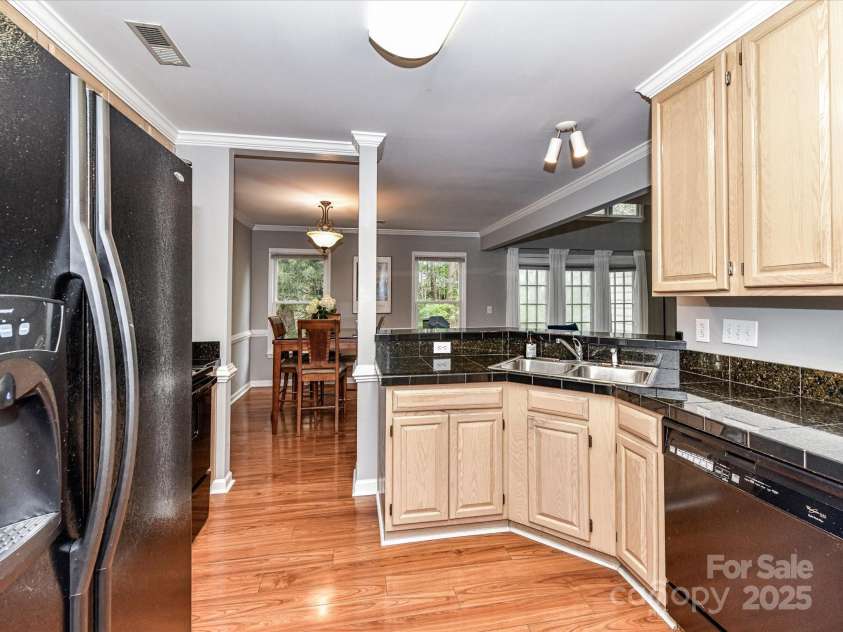4743 Morning Dew Court, Charlotte, NC 28269.  MLS# CAR4244275, YatesRealty ID 13756. Kitchen featuring a double sink and ample cabinetry for storage!
