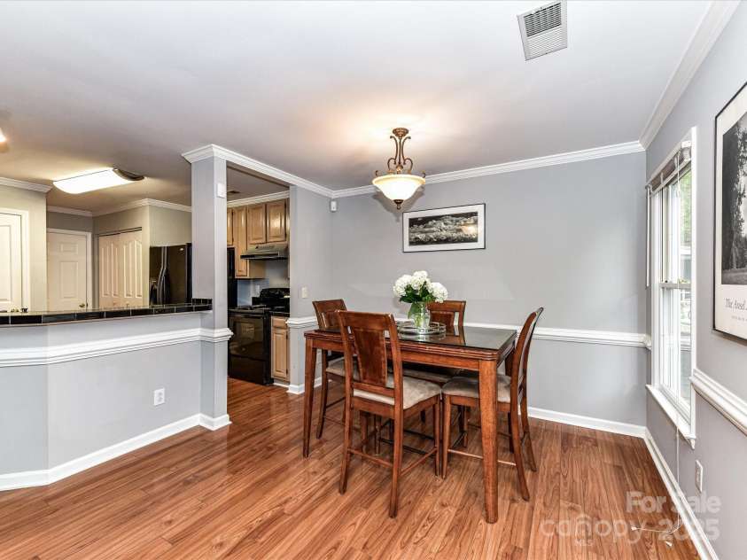 4743 Morning Dew Court, Charlotte, NC 28269.  MLS# CAR4244275, YatesRealty ID 13756. Open and airy Dining area with huge windows and elegant crown and chair moldings throughout.
