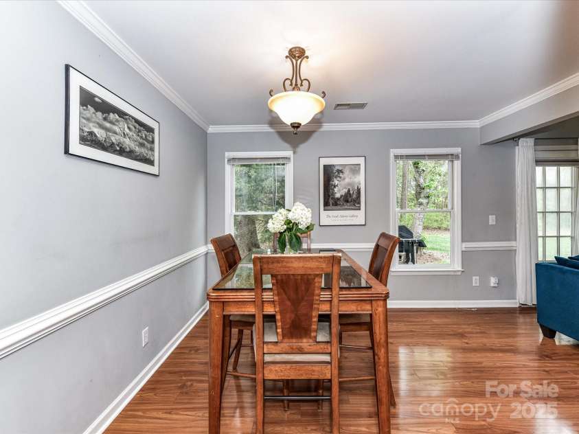 4743 Morning Dew Court, Charlotte, NC 28269.  MLS# CAR4244275, YatesRealty ID 13756. Open and airy Dining area with huge windows and elegant crown and chair moldings throughout.