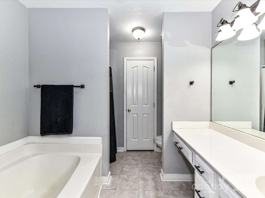 4743 Morning Dew Court, Charlotte, NC 28269.  MLS# CAR4244275, YatesRealty ID 13756. Primary bathroom with garden tub , shower, plenty of drawers for storage and a massive counter space!