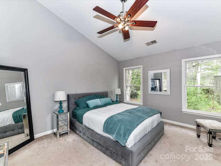 4743 Morning Dew Court, Charlotte, NC 28269.  MLS# CAR4244275, YatesRealty ID 13756. Primary Bedroom with tons of natural light, vaulted ceiling and ceiling fan/light  features walk in closet and primary bathroom.