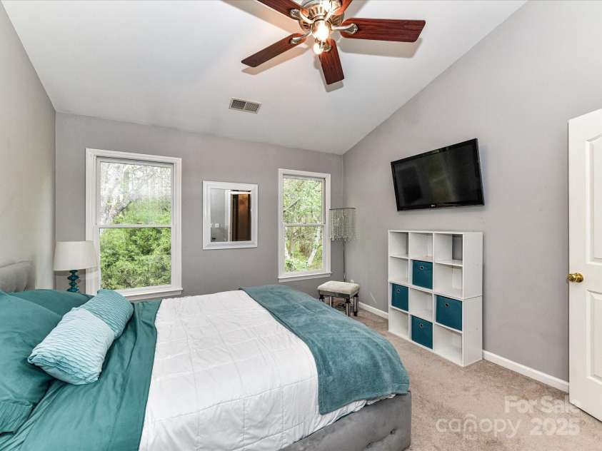4743 Morning Dew Court, Charlotte, NC 28269.  MLS# CAR4244275, YatesRealty ID 13756. Primary Bedroom with tons of natural light, vaulted ceiling and ceiling fan/light  features walk in closet and primary bathroom.