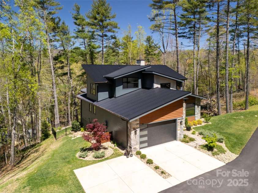 42 Spring Cove Road, Asheville, NC 28804.  MLS# CAR4246585, YatesRealty ID 13759. 2-car garage and 4 car parking. Plenty of room to expand garage for additional vehicles, workshop, artist studio, storage, etc., if ever desired.  Glimpse of whole home generator can be seen adjacent to house (behind j