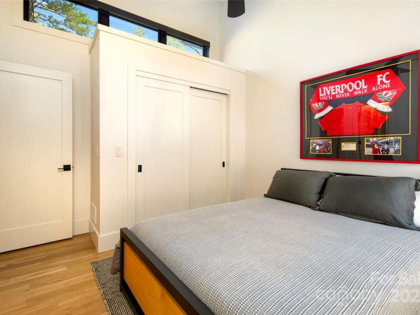 42 Spring Cove Road, Asheville, NC 28804.  MLS# CAR4246585, YatesRealty ID 13759. First of three spacious second floor bedrooms with vaulted ceilings, windows bringing in tons of natural light, and ample closet storage.